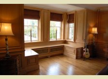 Polished pine window seating with built in radiator covers